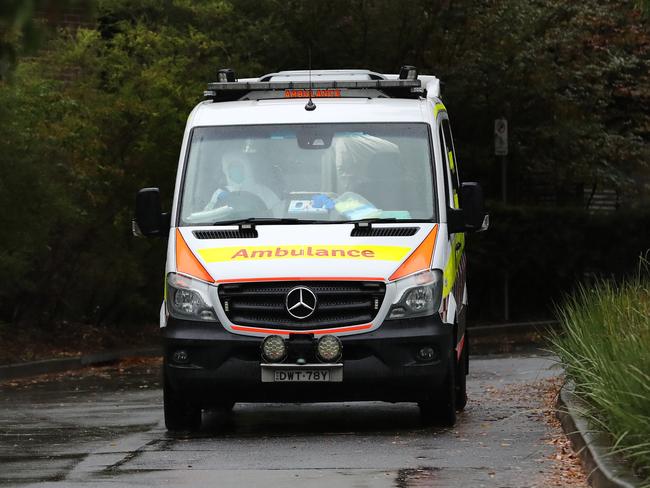 An ambulance leaves Anglicare's Newmarch House nursing home at Caddens in western Sydney yesterday. Picture: Richard Dobson