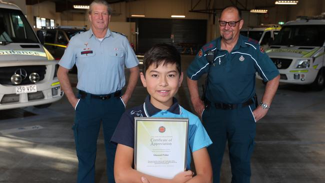 Eleven year old Maxwell Potter with his certificate of appreciation and paramedics Ralph Wilkinson (left) and Paul Neilsen (right) at Southport Ambulance Station. Picture Glenn Hampson