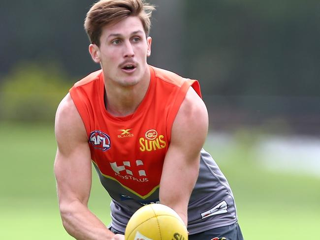 GOLD COAST, AUSTRALIA - MARCH 08:  David Swallow handballs during a Gold Coast Suns AFL training session at Bond University AFL Field on March 8, 2018 in Gold Coast, Australia.  (Photo by Chris Hyde/Getty Images)