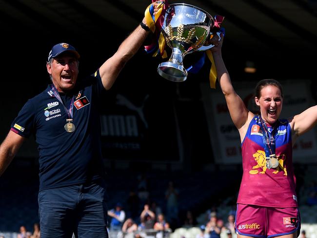 Lions coach Craig Starcevich and captain Breanna Koenen celebrate winning last season’s AFLW premiership. Picture: Morgan Hancock/AFL Photos/via Getty Images