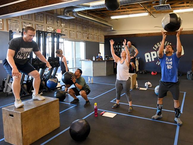 LAS VEGAS, NEVADA - MAY 29: People work out at CrossFit Apollo, which opened for the first time since closing on March 17 due to the statewide shutdown because of the coronavirus (COVID-19) pandemic on May 29, 2020 in Las Vegas, Nevada. As part of a phased reopening of the state's economy, gyms and fitness facilities were allowed to reopen today with social distancing guidelines and other restrictions in place.   Ethan Miller/Getty Images/AFP == FOR NEWSPAPERS, INTERNET, TELCOS & TELEVISION USE ONLY ==