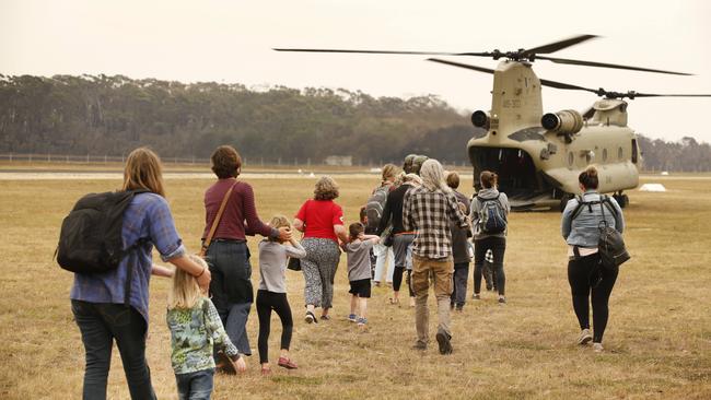 Families and children board a Chinook army helicopter bound for East Sale RAAF Base. Picture: David Caird