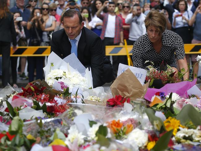 Prime Minister Tony Abbott and his wife Margie lay flowers at the memorial in Martin Place. Picture: Bradley Hunter