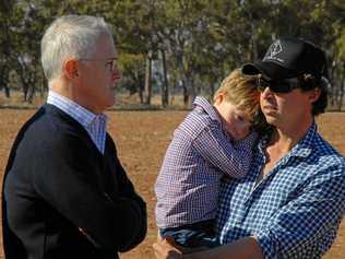 TOUGH TIMES: Prime Minister Malcolm Turnbull speaks with farmer Phillip Miles and his son Jack during his June visit to Strathmore Farm in Trangie NSW, as part of a tour of regional NSW and Queensland  communities struggling with drought. Picture: IVAN MCDONNELL