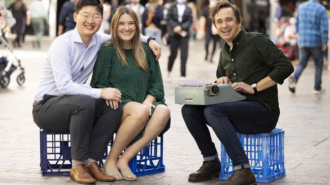 Bestselling author Trent Dalton interviews Ben and Sara Shi in Brisbane’s Queen Street Mall for his new book of true-life love stories. Picture: Glenn Hunt