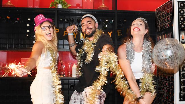 The Precinct staff members Katie Roache, Angelino Zidda and Danielle Jeavonns are getting ready for a bumper New Year's Eve, as Territory businesses brace for a big night. Picture: Katrina Bridgeford