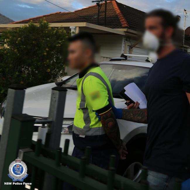 One of the men being led away following his arrest. Picture: NSW Police