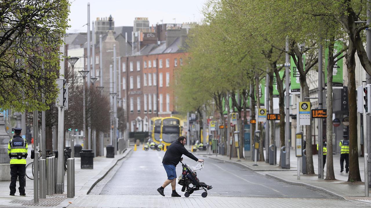 A man pushes a buggy across an almost deserted O'Connell Street in Dublin's city centre on Easter Sunday as restrictions remain in place to help curb the spread of the coronavirus. Picture: Brian Lawless/PA via AP