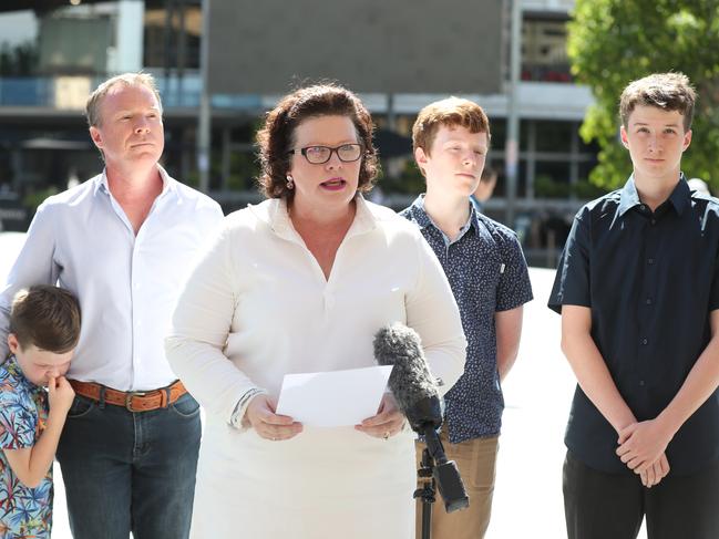 Kate Richards delivers her statement in front of Brisbane City Hall with husband Matthew and sons Hamish, 6, Dom, 15, and Will, 16. Picture: Annette Dew