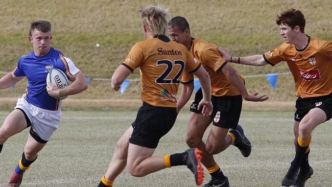 AICES's Nathan Cryer with the ball in a recent match against Country (Orange).