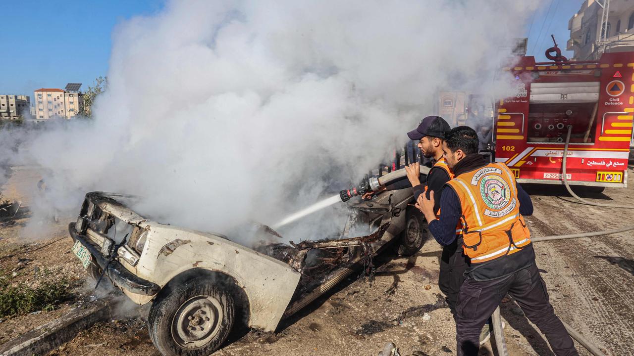 Members of the Palestinian Civil Defence extinguish a burning car following Israeli bombardment in Rafah. Picture: AFP