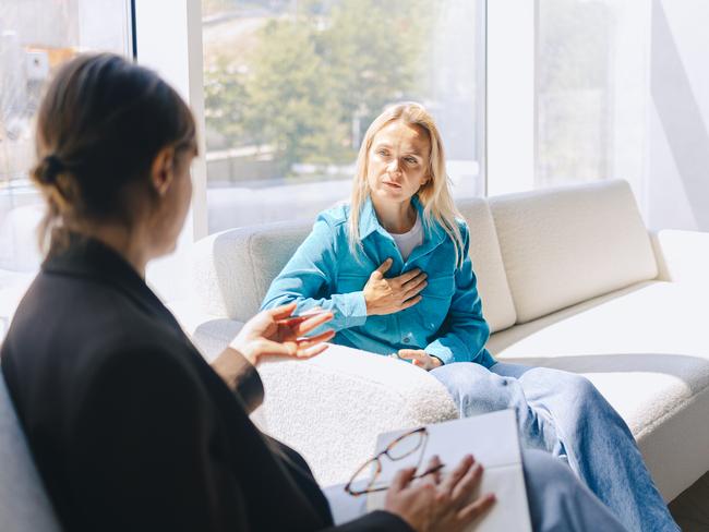 Two women sitting in armchairs and talking. Female coach, psychotherapist, psychologist, advisor and patient, client, psychotherapy. Pain and heartache