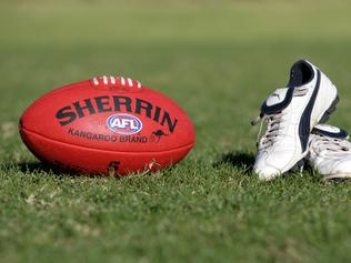 Generic AFL Sherrin football and football boots. sport /