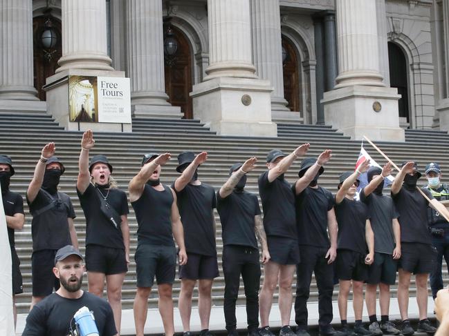 MELBOURNE, AUSTRALIA - NewsWire Photos, MARCH 18, 2023. Protest groups face off in front of the Victorian Parliament where UK far right activist Kellie-Jay Keen is due to speak. Far right wing group does Nazi salutes on the steps of  of Parliament. Picture: NCA NewsWire / David Crosling