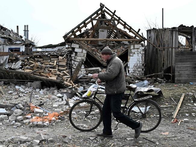 A local resident walks past destroyed houses in the village Velyka Pysarivka, which lies just five kilometres from the Russian border, in Sumy region. Picture: AFP