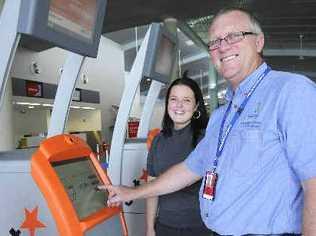 Inspecting one of Jetstar’s new DIY check-in kiosks at the Ballina-Byron Gateway Airport are airport operations manager Graeme Gordon and office administrator Sam McGrath. . Picture: Doug Eaton