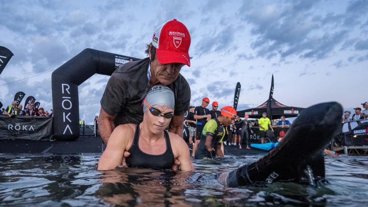 Coach Brad Fearnley helping parker at the start of the 1.9km swim leg. Pic: Donald Miralle/IRONMAN)