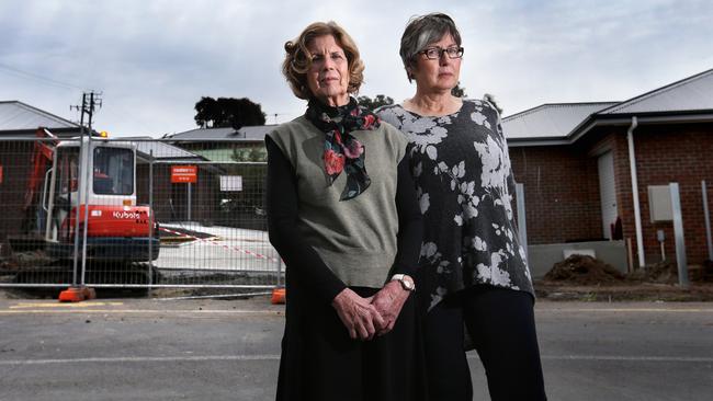 <s1>Chris Needham and Anne Harrison, of Blackmans Bay, at a four-unit development in their suburb they say represents why they are opposed to the new planning scheme.  </s1>Picture: NIKKI DAVIS-JONES