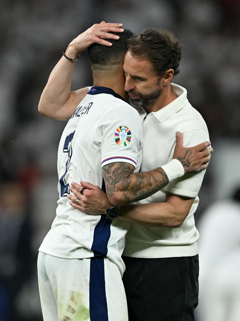 Southgate embraces Kyle Walker after England’s crushing defeat. (Photo by INA FASSBENDER / AFP)