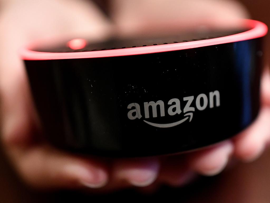 FILE- In this Aug. 16, 2018, file photo a child holds his Amazon Echo Dot in Kennesaw, Ga. Amazon.com Inc. reports earnings Thursday, Oct. 25. (AP Photo/Mike Stewart, File)