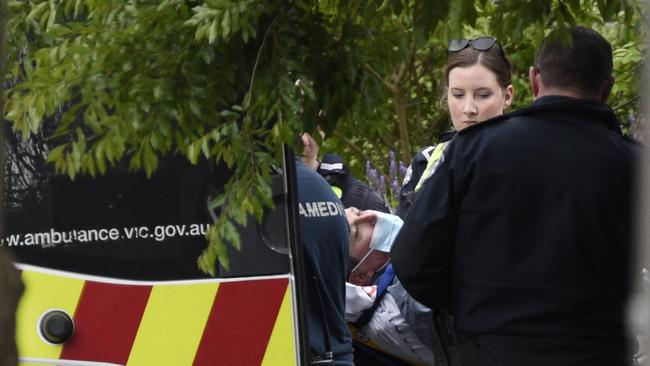 A man is loaded into an ambulance. Picture: Andrew Henshaw