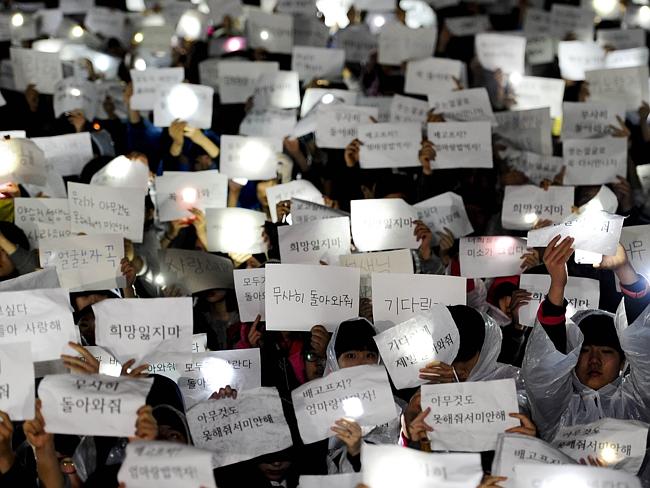 Showing support ... students at Danwon High School hold letters for students who are among the missing passengers of a South Korean capsized ferry.