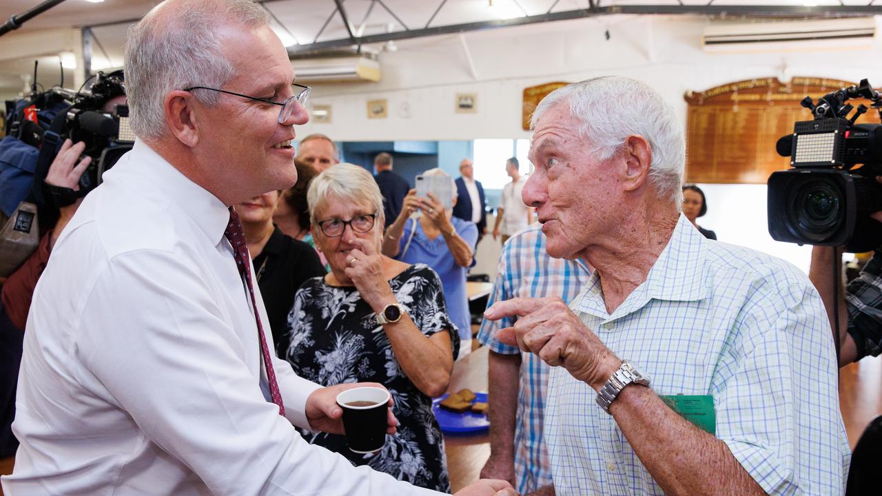 Scott Morrison mixed with locals at a Cairns darts club (above). Picture: Jason Edwards