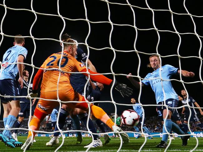 Victory goalkeeper Lawrence Thomas is unable to stop the opening goal by Aaron Calver. 