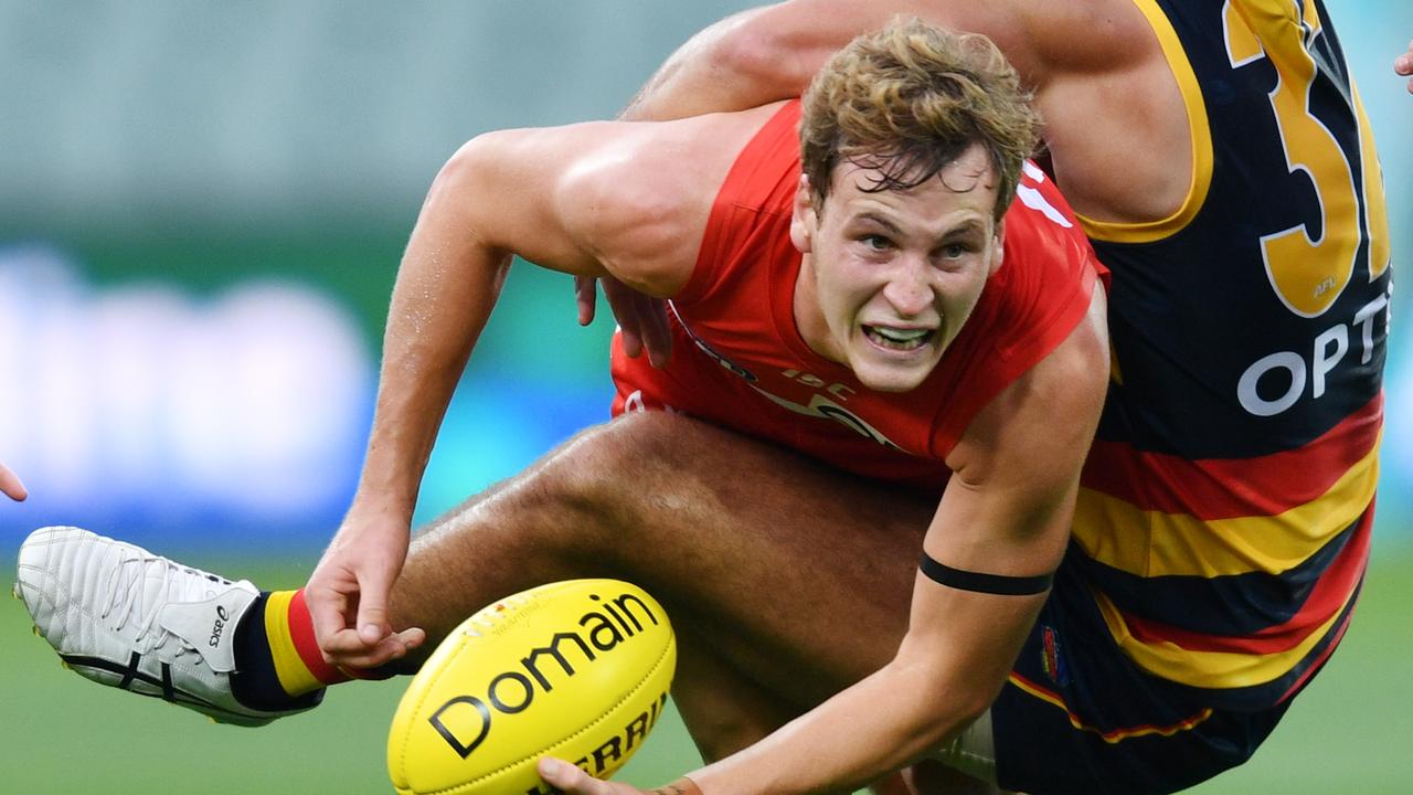 Jordan Dawson of the Swans is tackled by Darcy Fogarty of the Crows. Picture: David Marauz