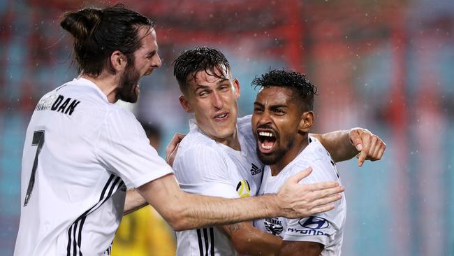Cillian Sheridan and Louis Fenton of the Phoenix embrace Roy Krishna of the Phoenix as he celebrates scoring a goal against the Wanderers last night. Picture: Getty Images