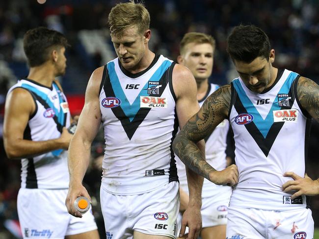 Power players leave the field after their loss to Essendon.