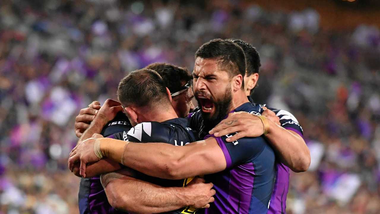 Storm players celebrate after scoring a try during the NRL grand final 2017. Police are bracing themselves for a spike in family violence this grand final weekend. Picture: MICK TSIKAS