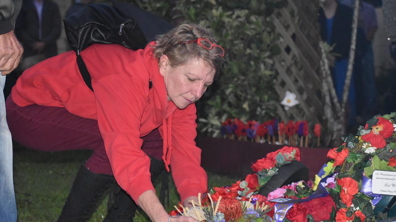 A person laying a wreath for the ANZACs at the Kuttabul dawn service at the Hampden State School Remembrance Garden 2021. Picture: Lillian Watkins