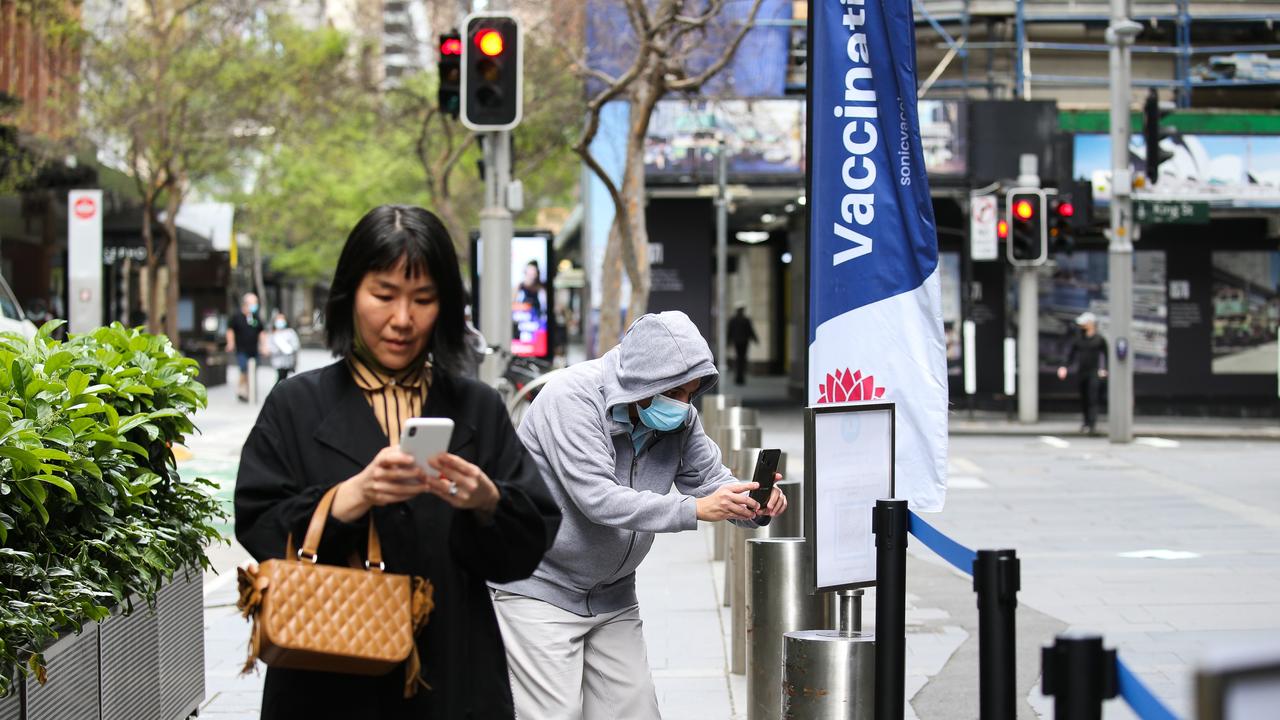 People are seen in Sydney’s CBD at the Pitt Street Covid-19 pop up vaccination hub. Picture: NCA NewsWire/ Gaye Gerard