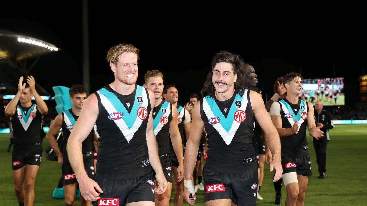 Captain Tom Jonas walks off with Jones after the win. Picture: Sarah Reed/AFL Photos/Getty Images