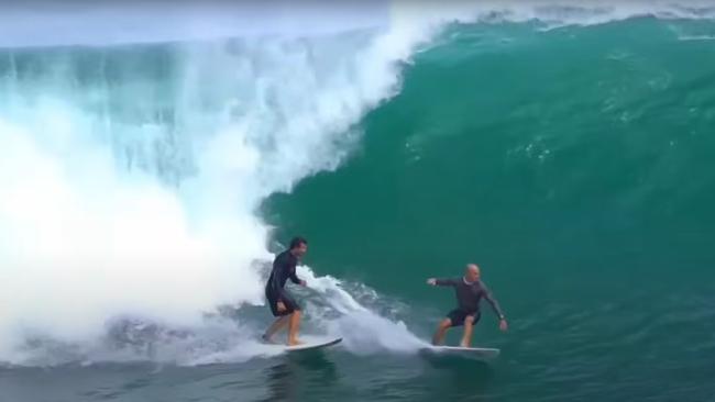 JP Azevedo who was filmed punching a female surfer in April, has been spotted surfing in Bali with Kelly Slater, who condemned the attack at the time. Picture: YouTube