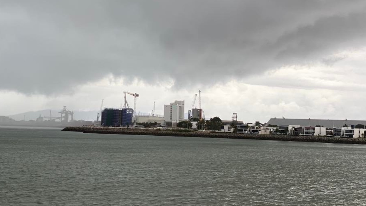 Dark clouds and rain close in on the Port of Townsville on Saturday.