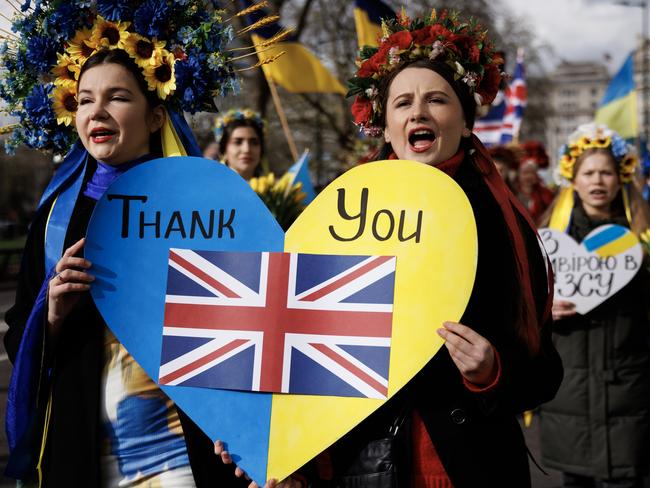 People with placards and Ukrainian flags participate in a march in London on February 24 to mark two years since the beginning of the Russian invasion of Ukraine. Picture: Dan Kitwood/Getty Images