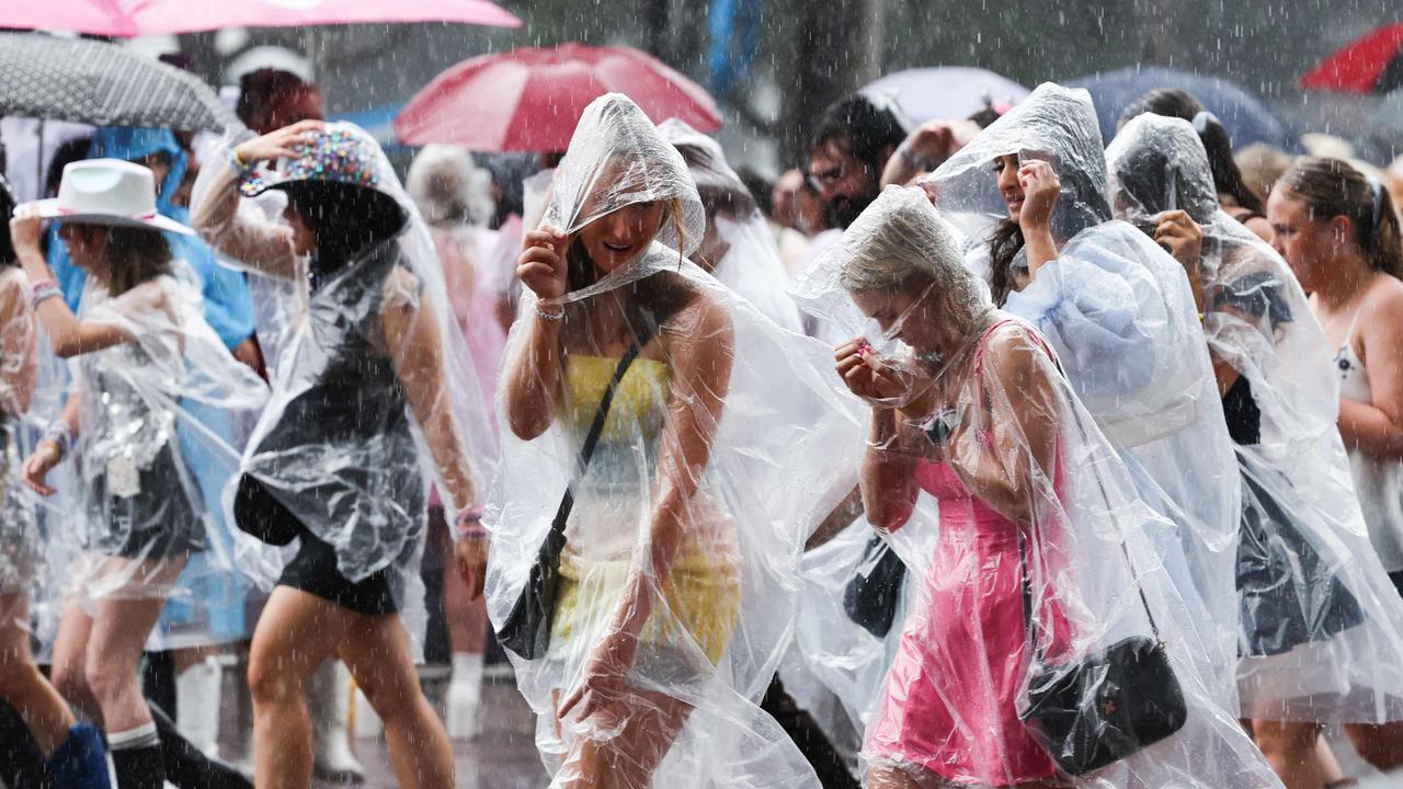 Fans got pelted with rain on the way in – but miraculously, the rain held off during the show. Picture: DAVID GRAY / AFP