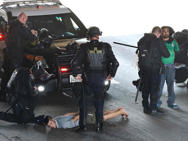 California Highway Patrol (CHP) officers detain protesters blocking the 101 freeway. Picture: Mario Tama/Getty Images/AFP