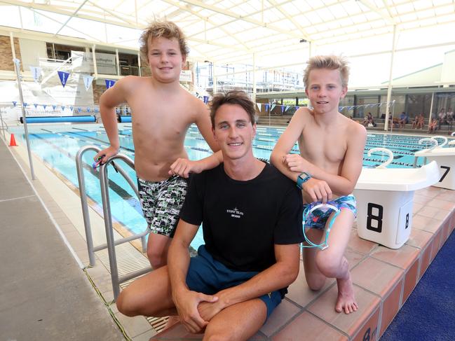 Australian swimmer Cam McEvoy with Emmanuel Collage students Ethan Babic and Cooper Leary. Picture: Richard Gosling