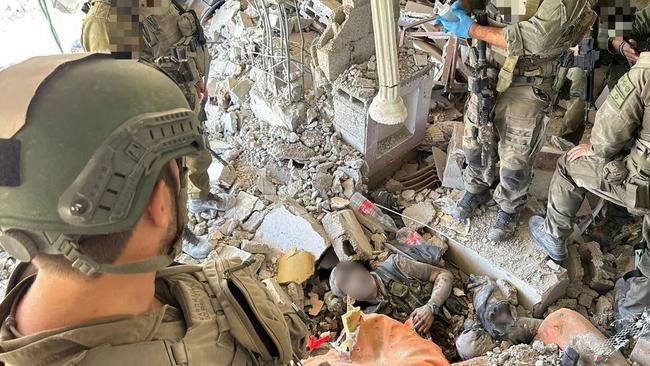 Israel Defence Forces troops surround the body of Hamas terror chief Yahya Sinwar in Gaza on Thursday. Picture: IDF