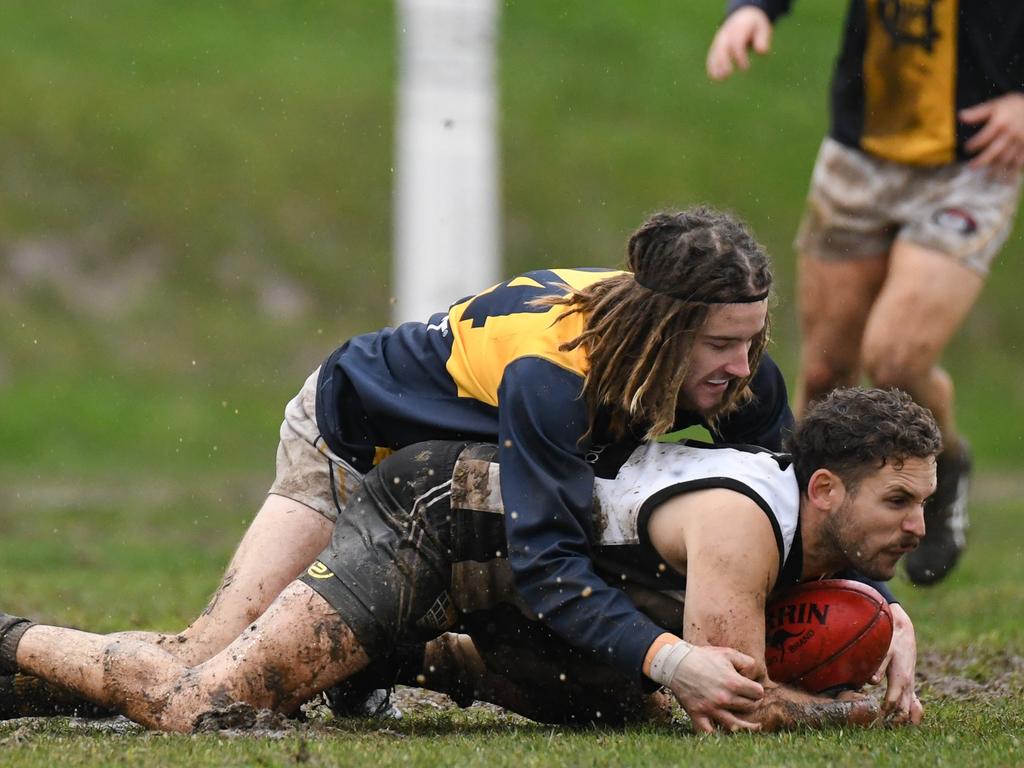 Hurstbridge and Montmorency do battle in tough conditions in Northern FL. Pictures: Nathan McNeill.