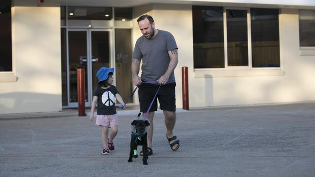 Loki heads home with Rosie King, four, and her father, Nathan King. Picture: Mark Cranitch