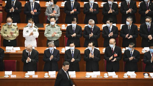 Delegates applaud as Chinese President Xi Jinping arrives for the opening of the National People’s Congress in the Great Hall of the People in Beijing. Picture: Getty Images