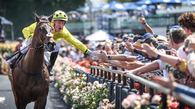 Mark Zahra high fives the crowd as he returns to the mounting yard with Without A Fight. Picture: Picture: David Caird