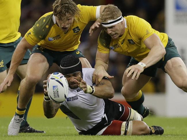 Fiji's Netani Talei is tackled by Australia's David Pocock, right, and Michael Hooper during the Rugby World Cup Pool A match between Australia and Fiji at the Millennium Stadium, Cardiff, Wednesday, Sept. 23, 2015. (AP Photo/Matt Dunham)