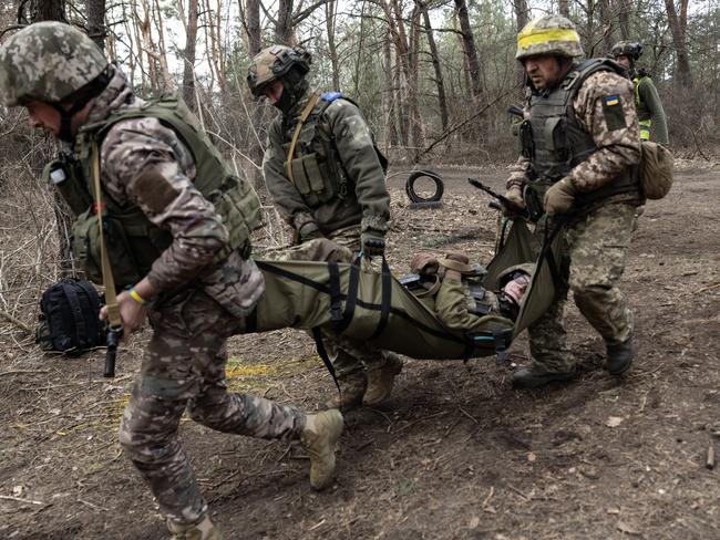 DNIPROPETROVSK REGION, UKRAINE - MARCH 13: Newly recruited Ukrainian soldiers with the 33rd Separate Mechanized Brigade practice carrying a wounded soldier during military training on March 13, 2025 in Dnipropetrovsk, Ukraine. Ukraine has agreed to a US-backed proposal for a 30-day ceasefire, with Russia yet to issue an official response. (Photo by Paula Bronstein/Getty Images)