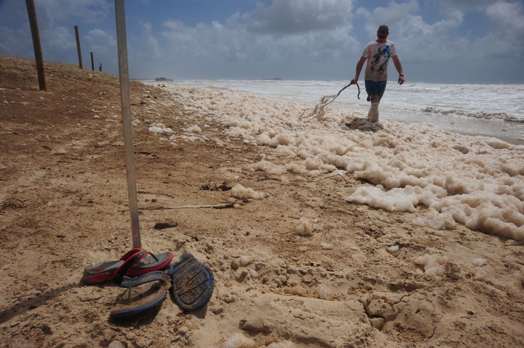 Foam covers Maroochydore Beach after heavy rain and large seas. Picture: Brett Wortman