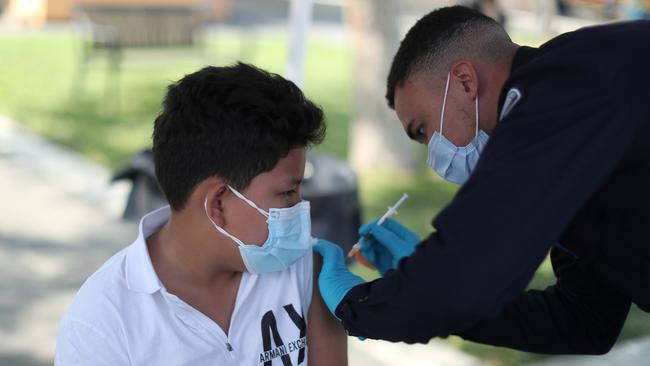 Alessandro Roque, 12, receives the Pfizer vaccine in Arleta, Los Angeles, on Monday. Picture: Reuters